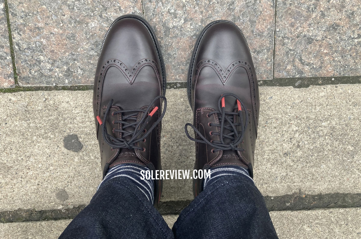 The Cole Haan Grand Ambition Wingtip Oxford on the sidewalk