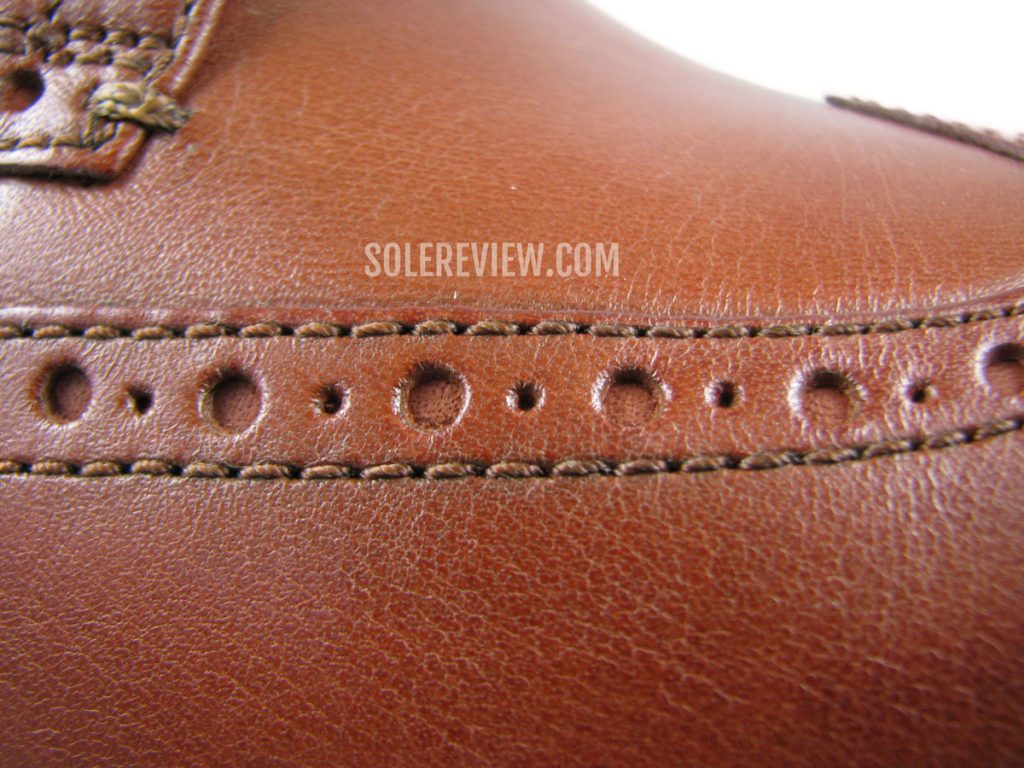 The corrected grain leather of the Cole Haan Originalgrand Wingtip Oxford.