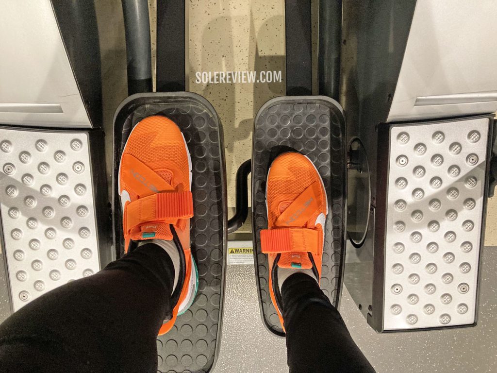 The Nike Metcon 7 Flyease on an elliptical stepper.