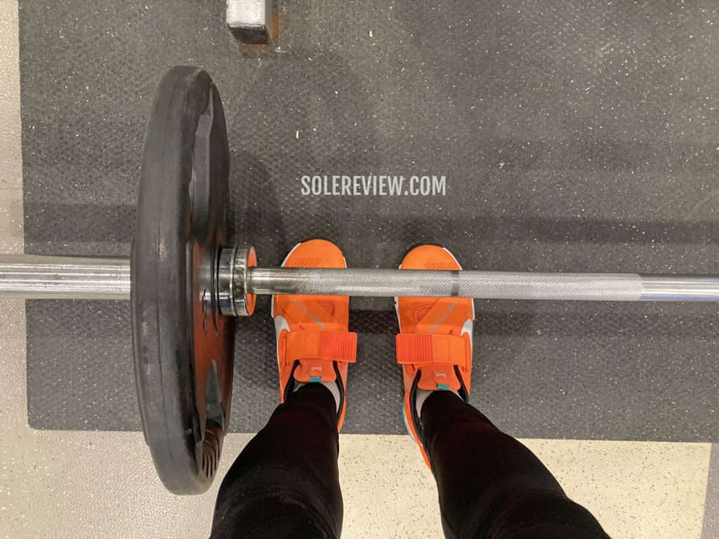 The Nike Metcon 7 Flyease with a deadlift bar.
