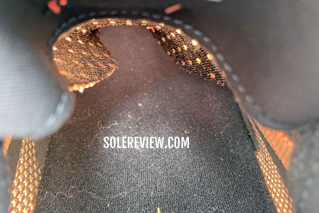 The folded tongue edges of the adidas Solarglide 5.