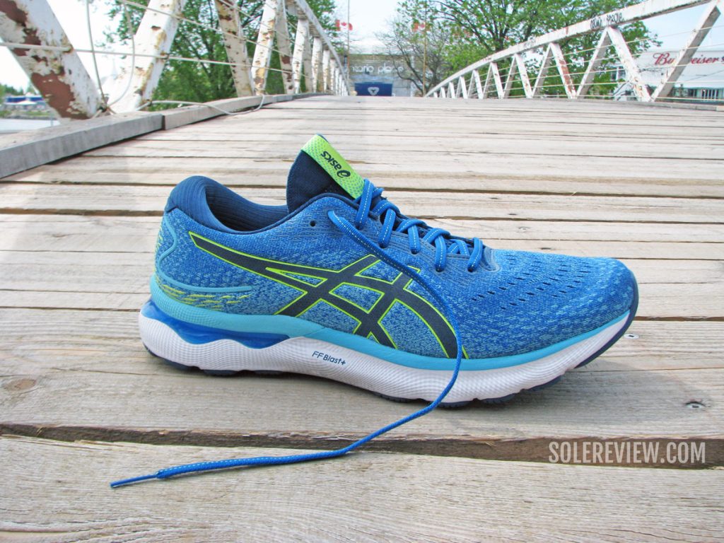 The Asics Nimbus 24 on a footbridge.