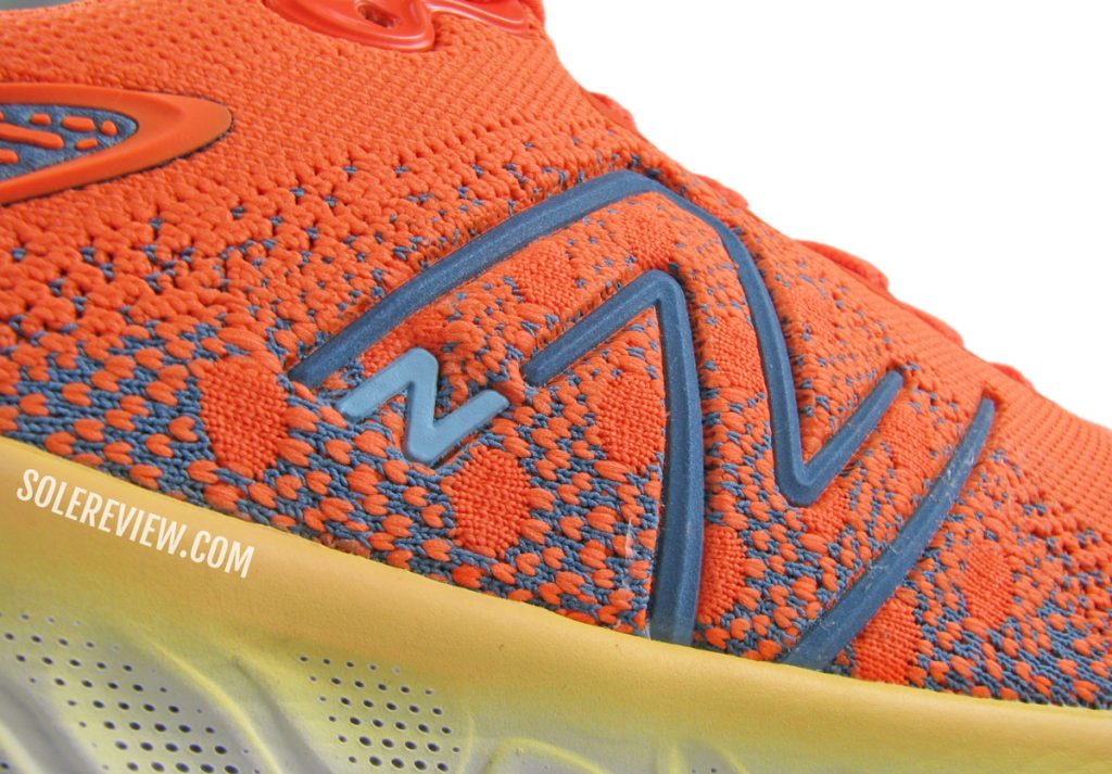 The midfoot logo of the New Balance Fresh Foam X 1080 V12.