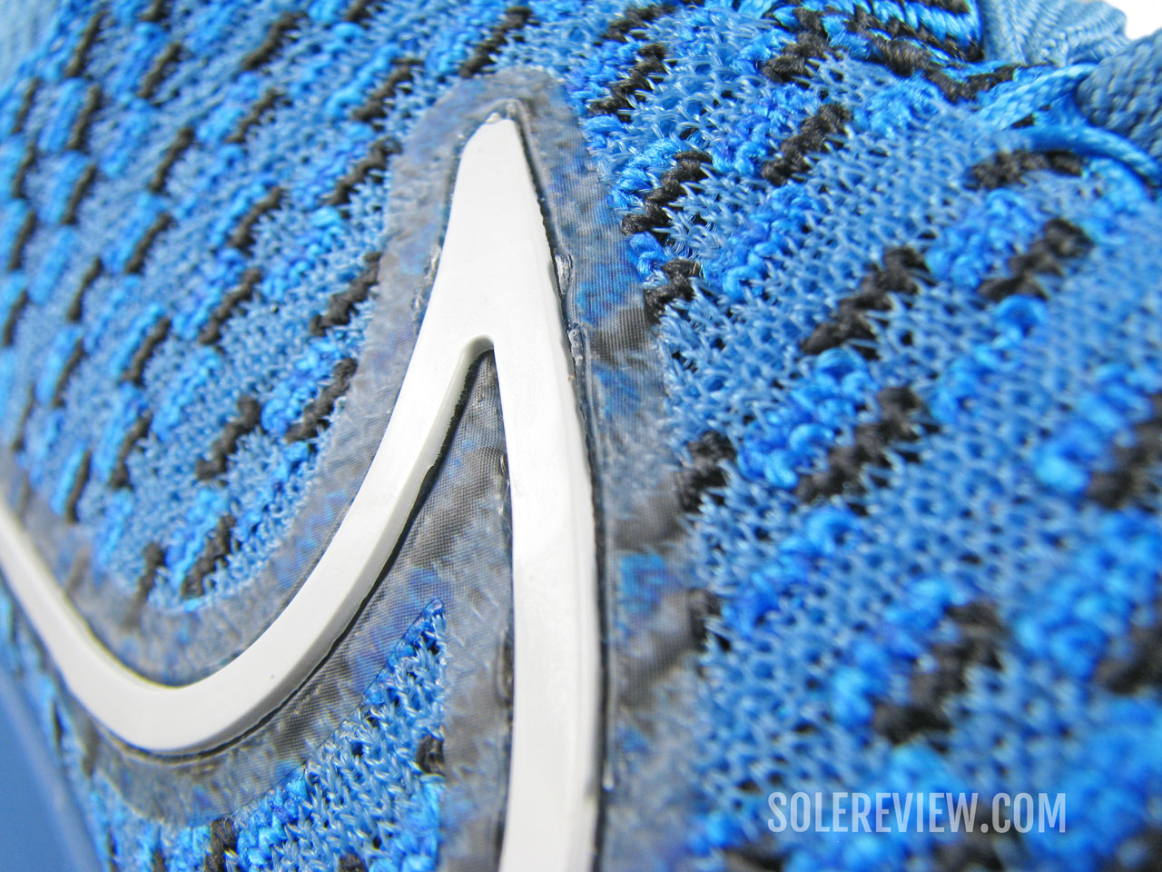 The molded Swoosh logo on the Nike React Infinity Run 3 Flyknit.