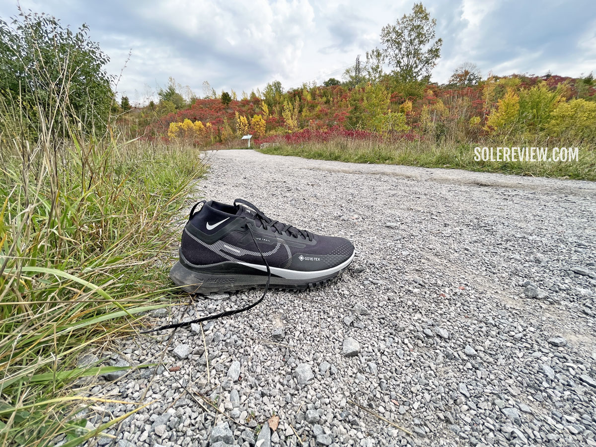 The Nike Pegasus Trail 4 on a gravel path.