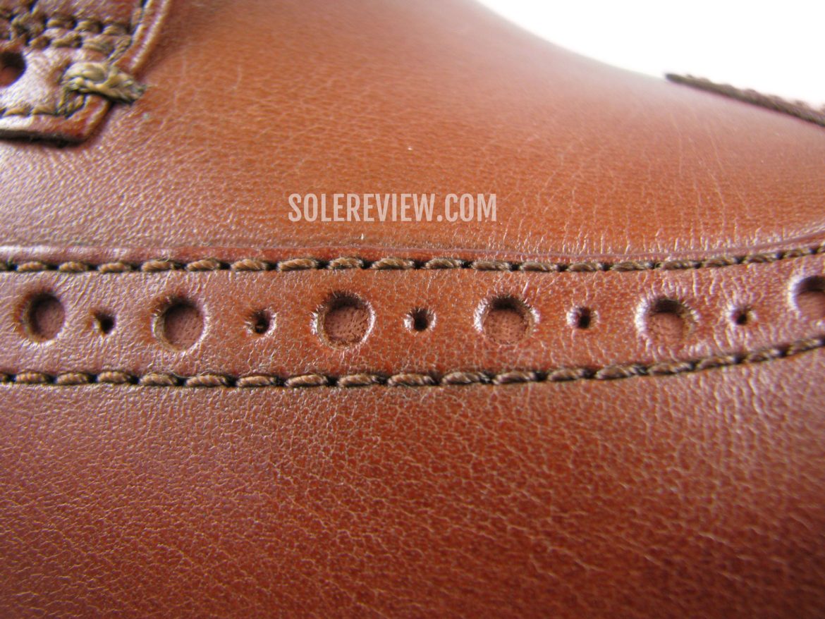 The brogue details of the Cole Haan Originalgrand Wingtip.
